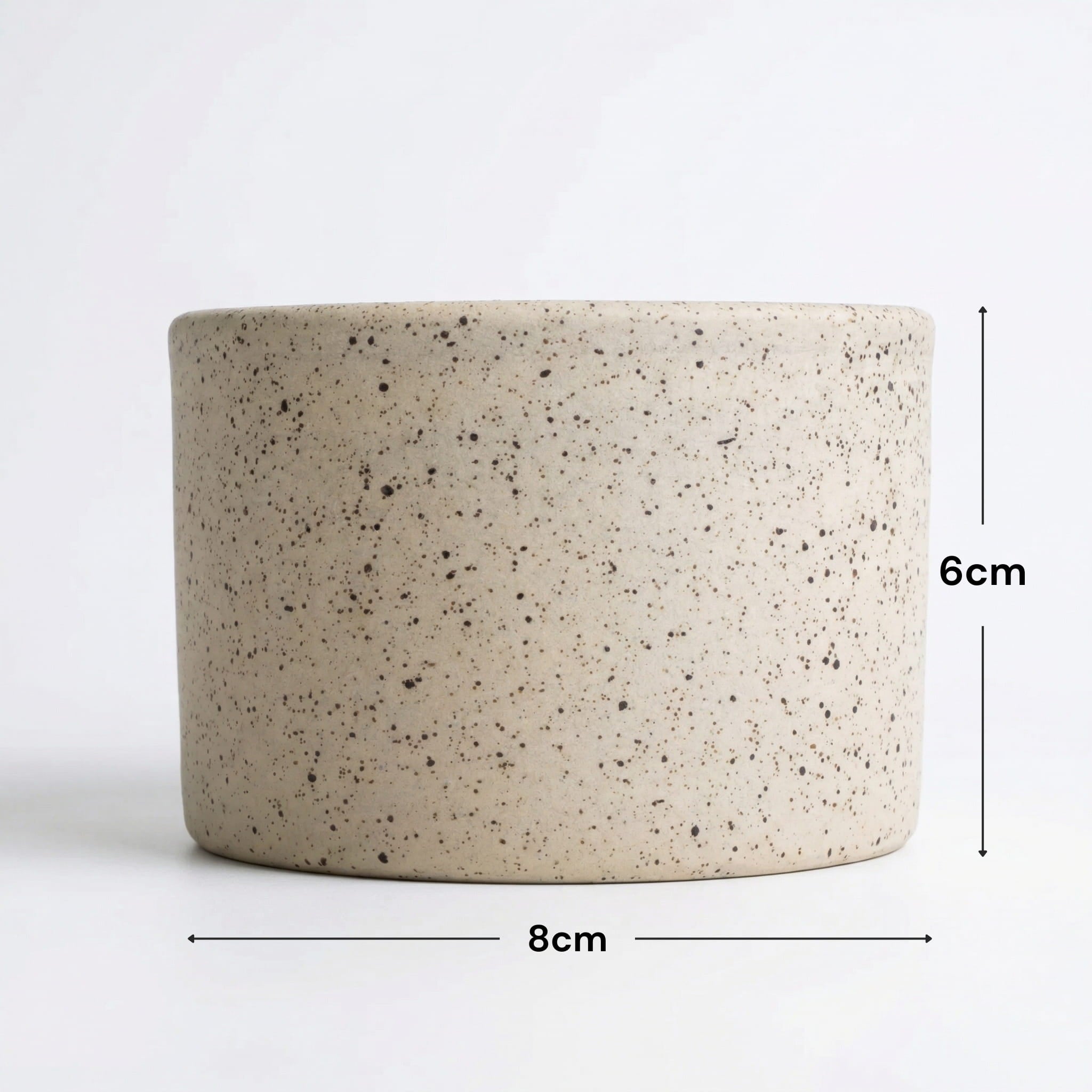 Speckled ceramic planter with dimensions on a white background
