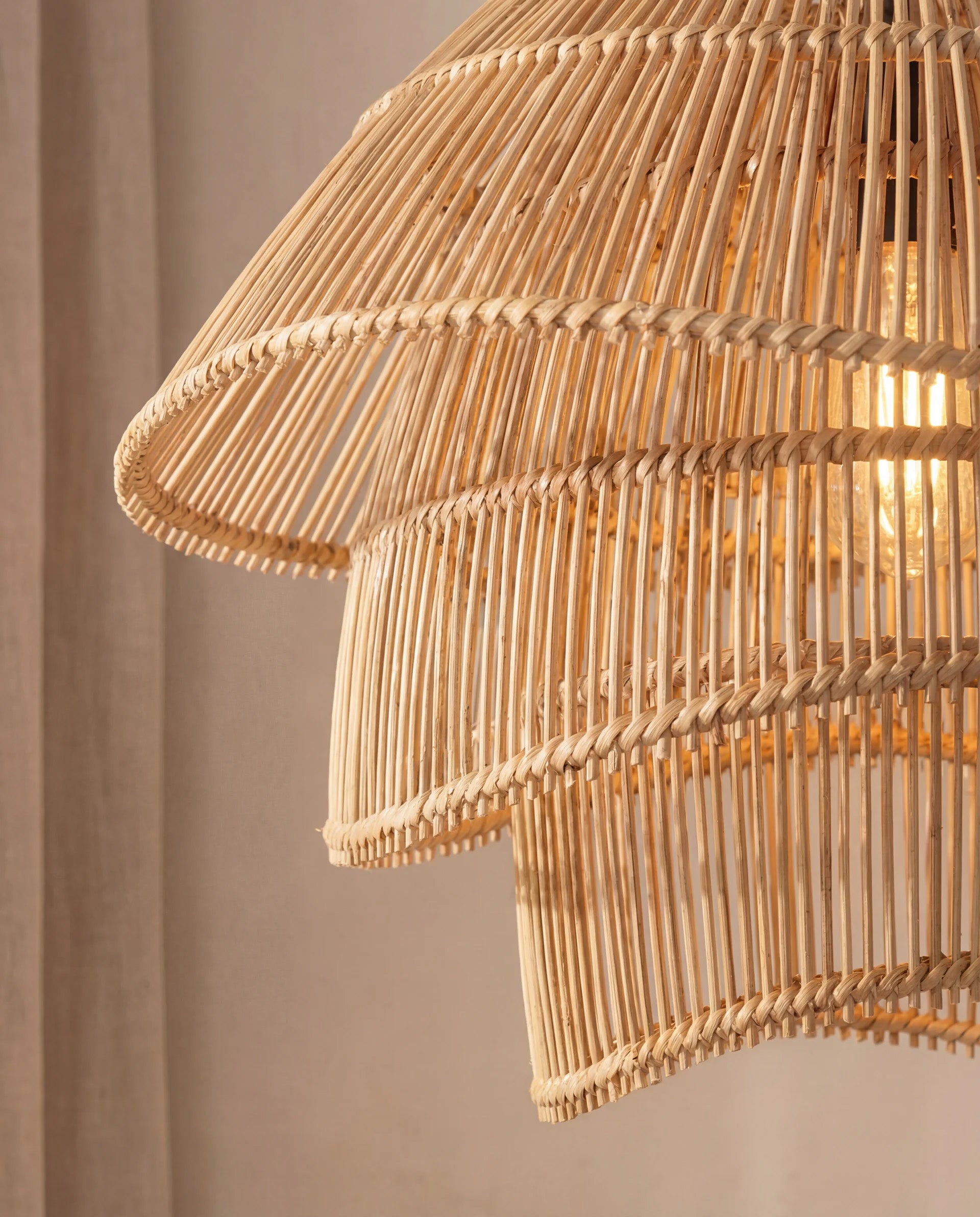 Close-up of a wicker lampshade against a neutral background