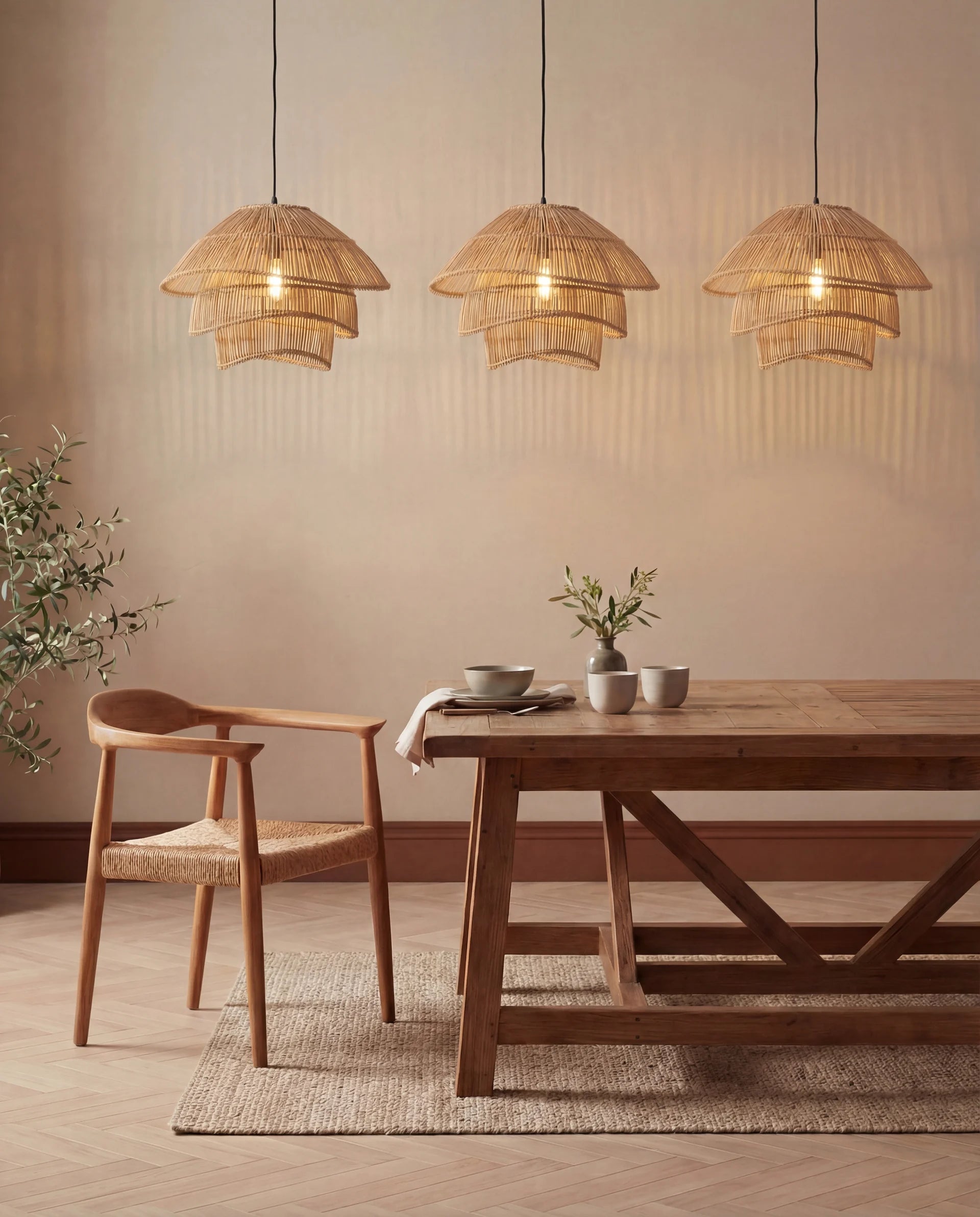 Dining room with wooden table and chairs, and three hanging wicker lamps.