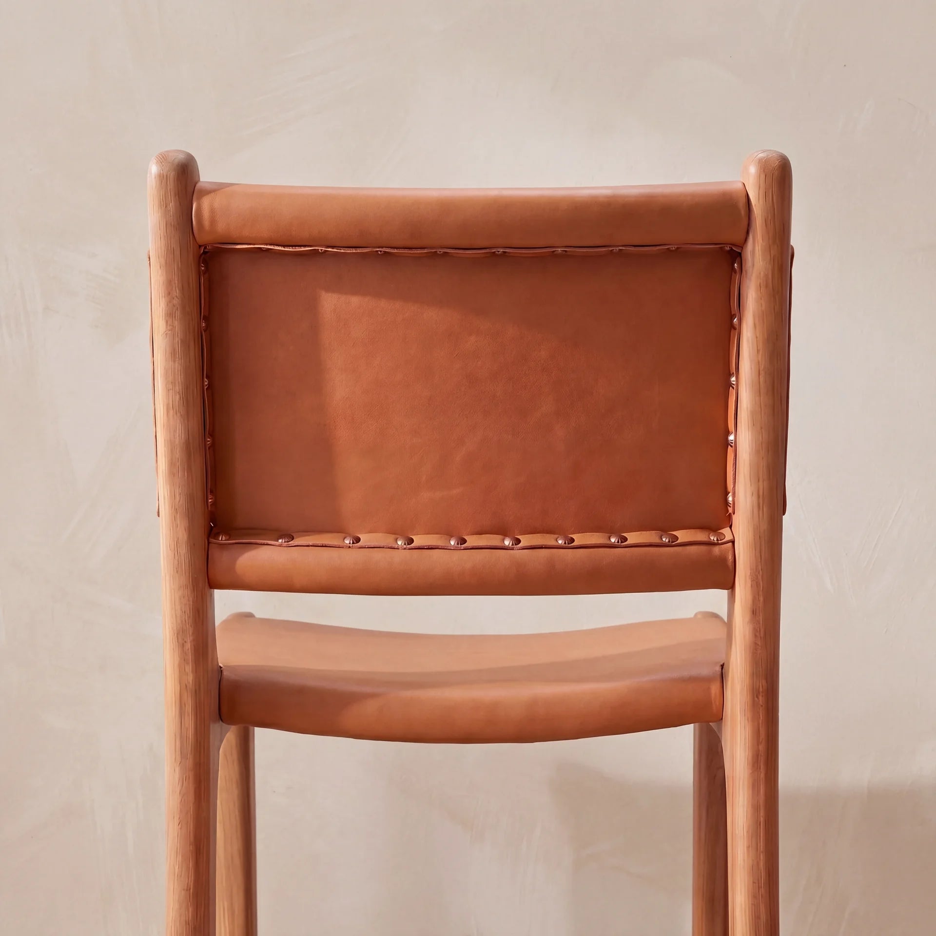 Close up of the back of a leather bar stool