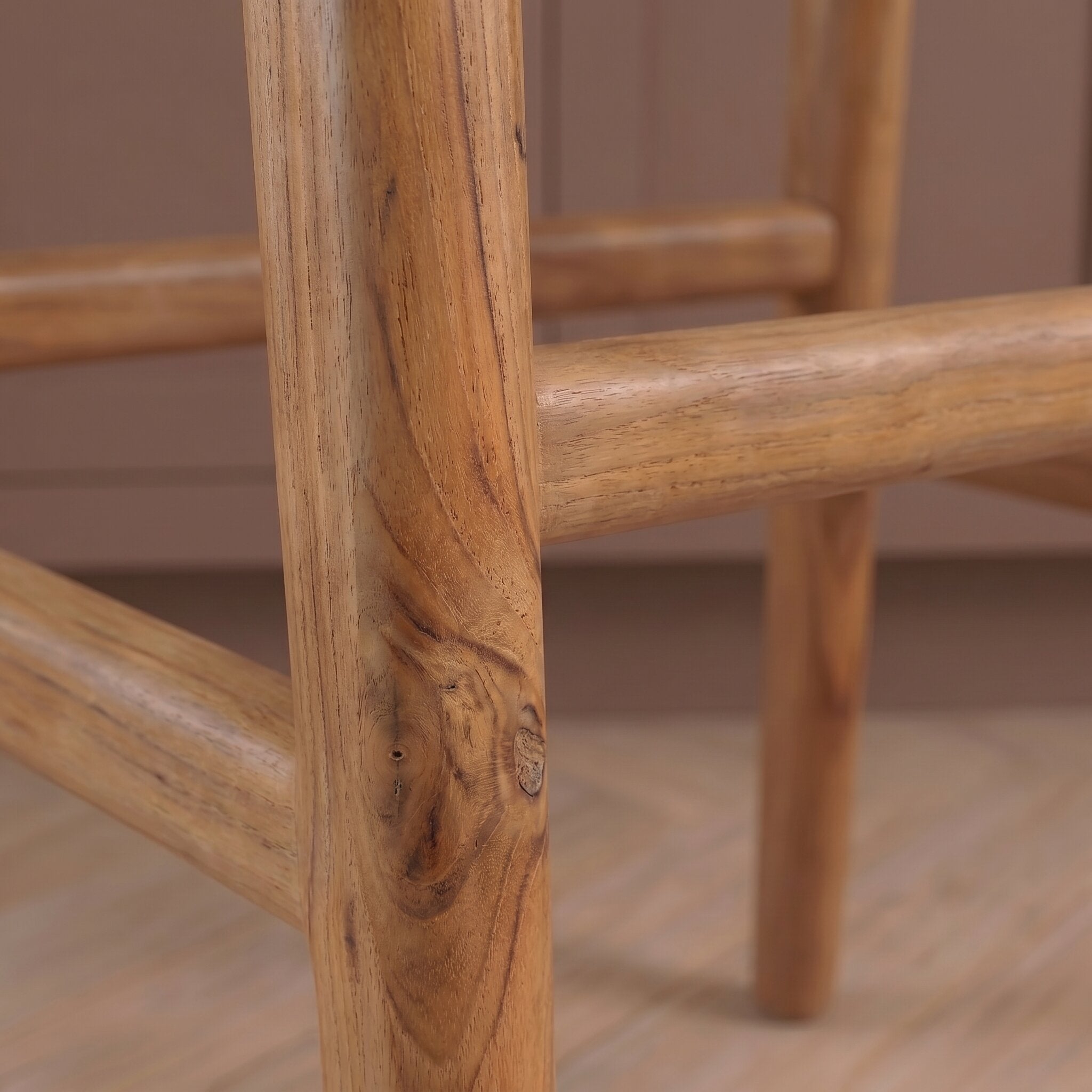 Close-up of a wooden chair frame with a blurred background