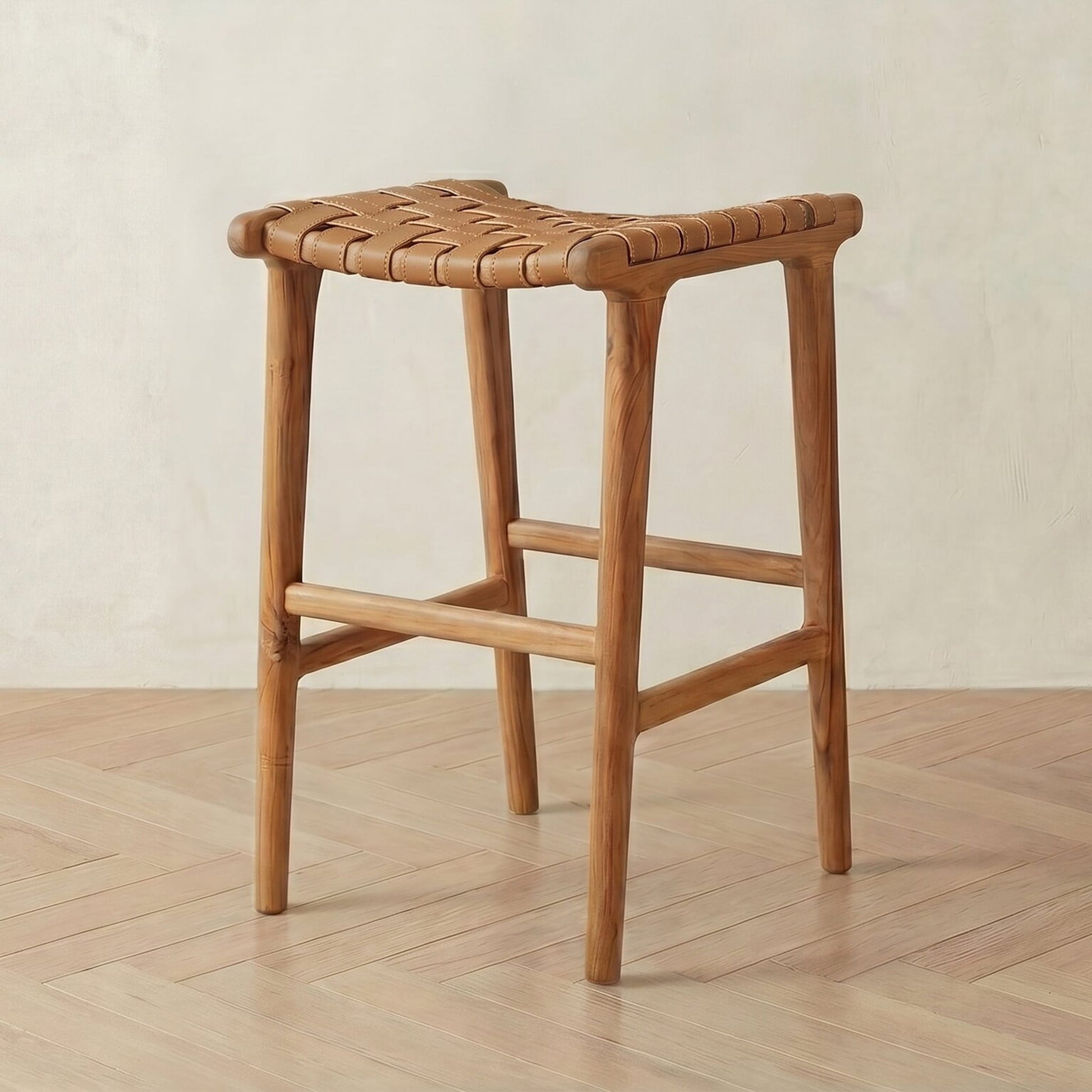 leather bar stool with woven seat on a wooden floor.