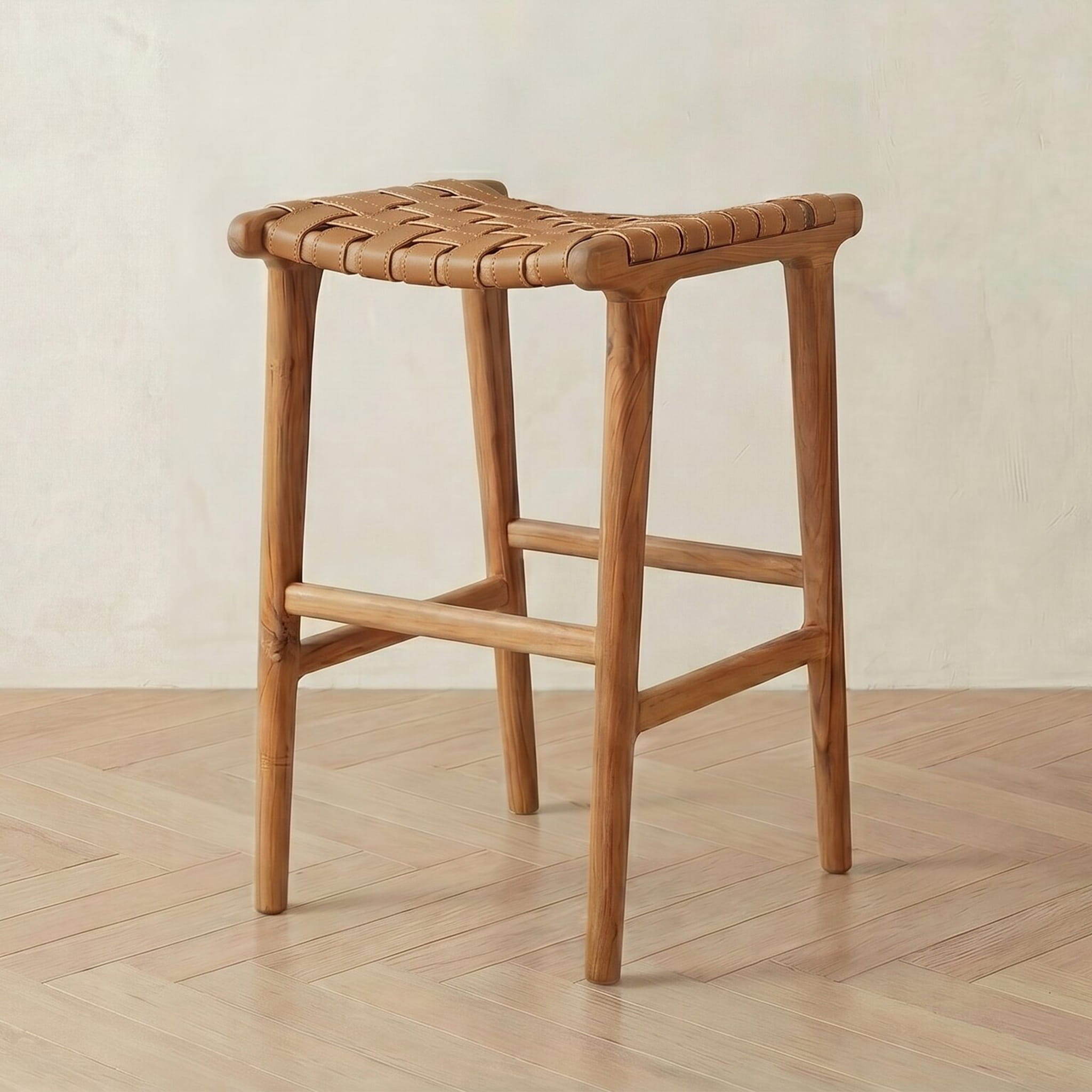 leather bar stool with woven seat on a wooden floor.