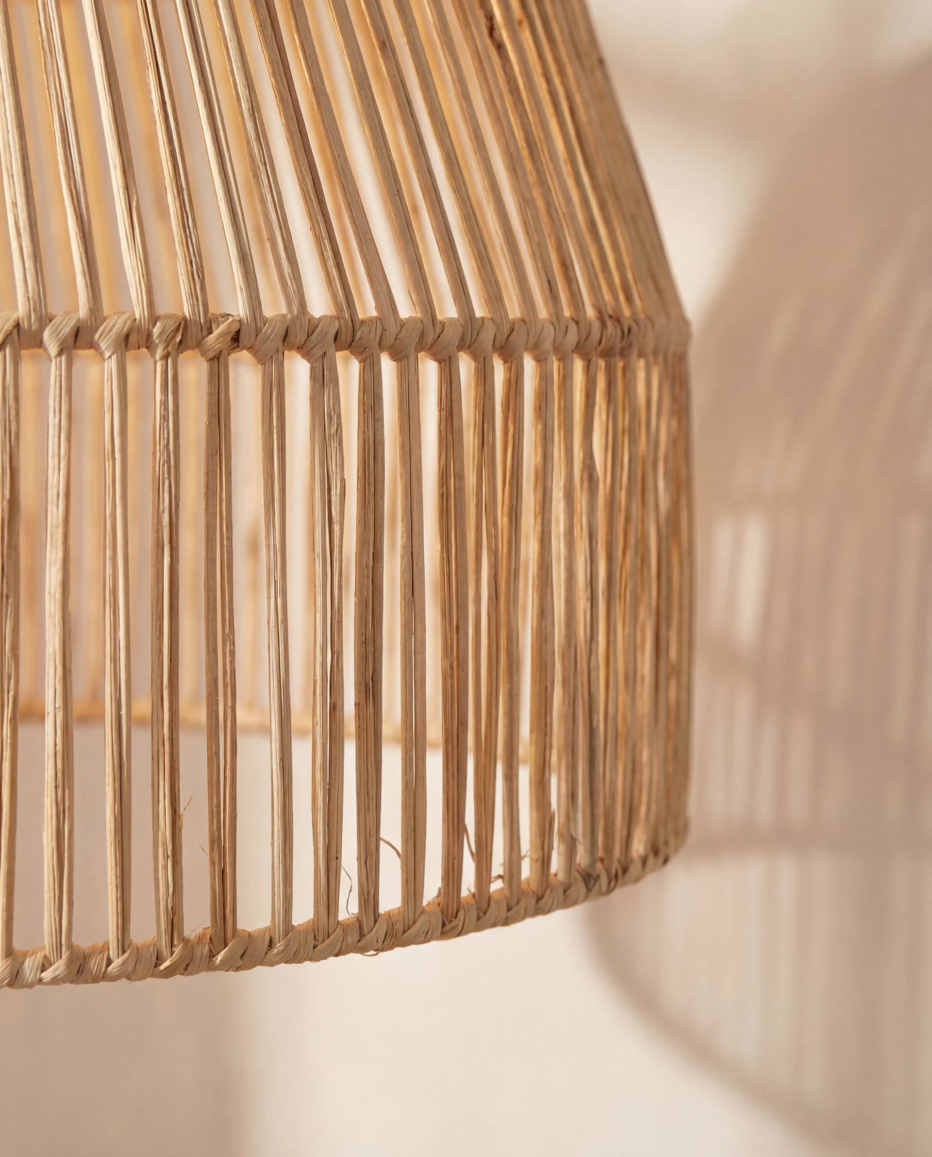 Woven rattan lampshade on a neutral background