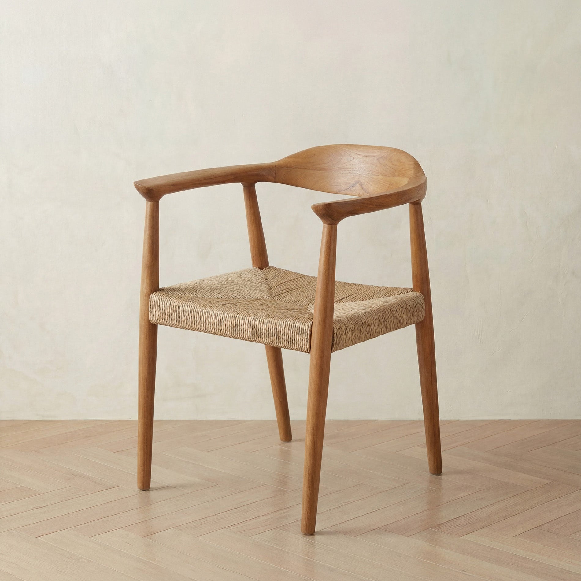 Wooden chair with woven seat on a wooden floor and beige wall background