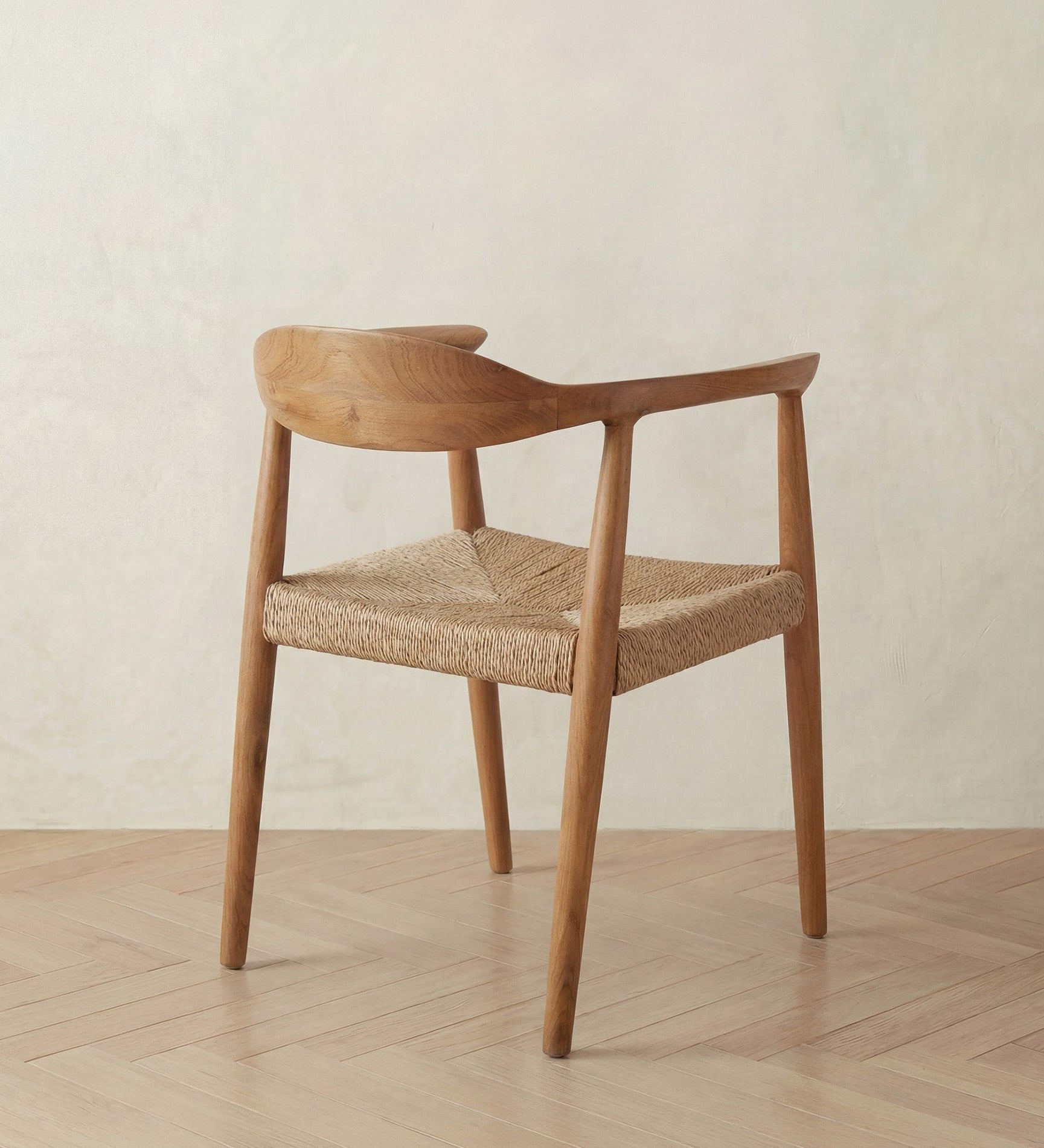 Wooden chair with woven seat on a wooden floor and light background