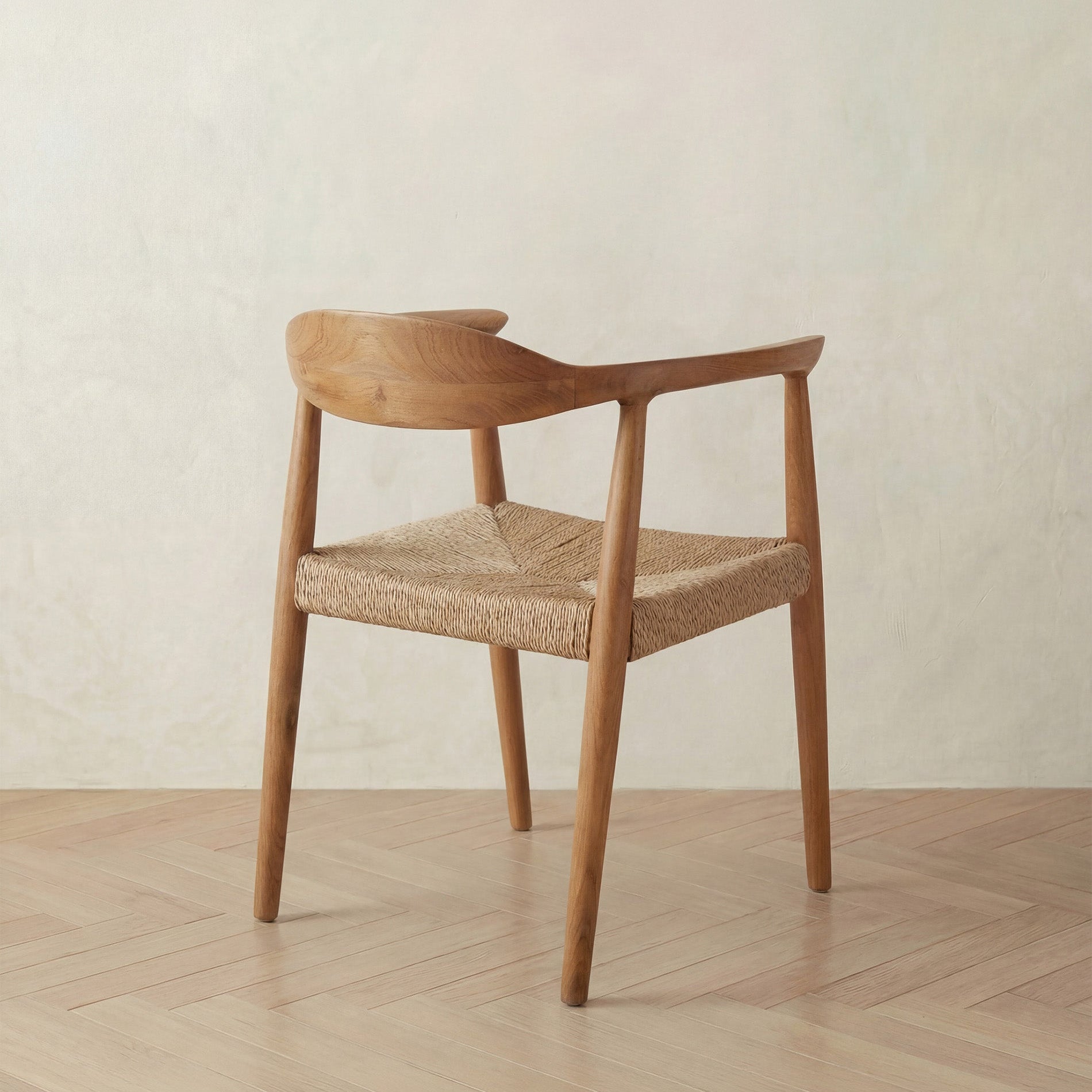 Wooden chair with woven seat on a wooden floor and light background