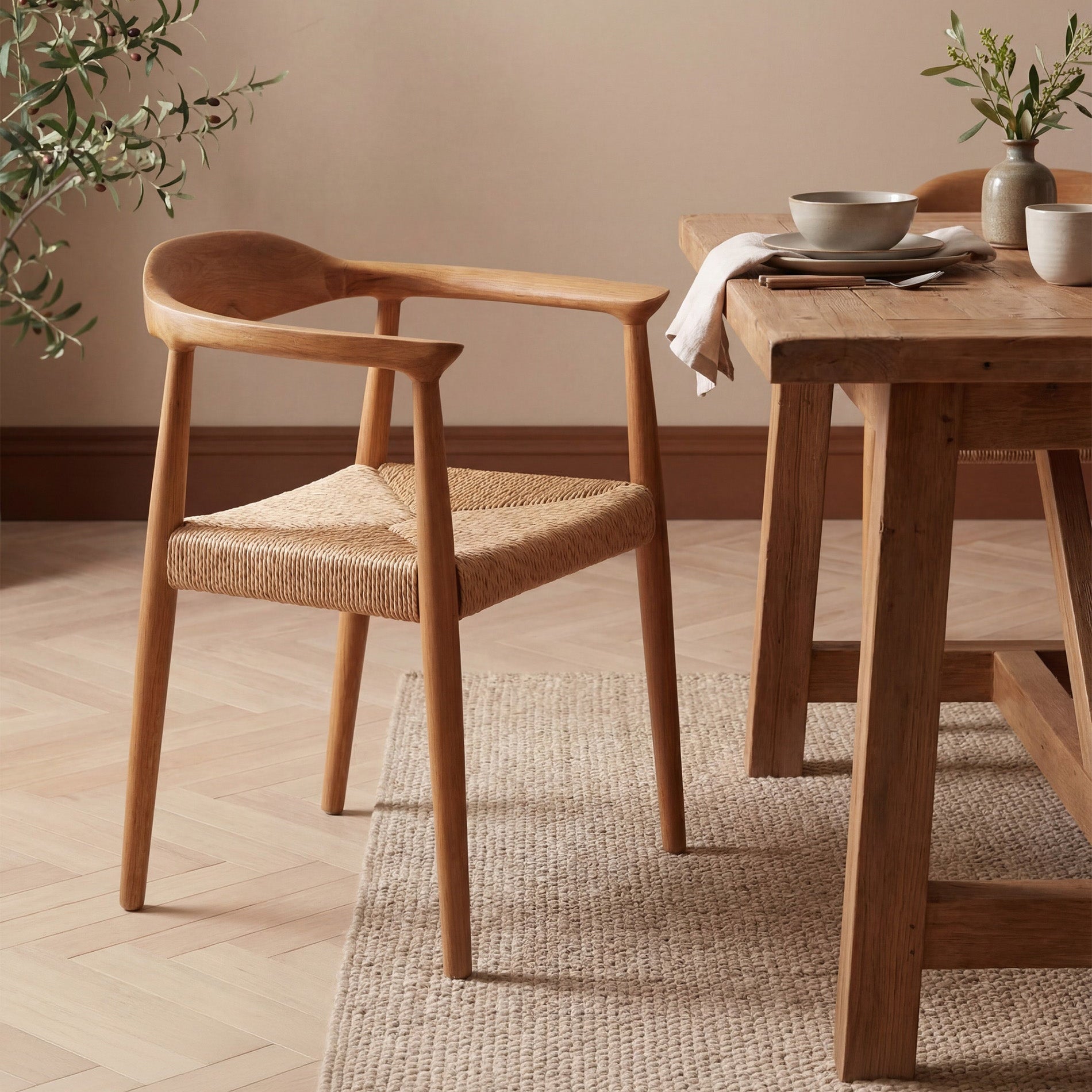 Wooden dining table with chairs in a room with a neutral color scheme.