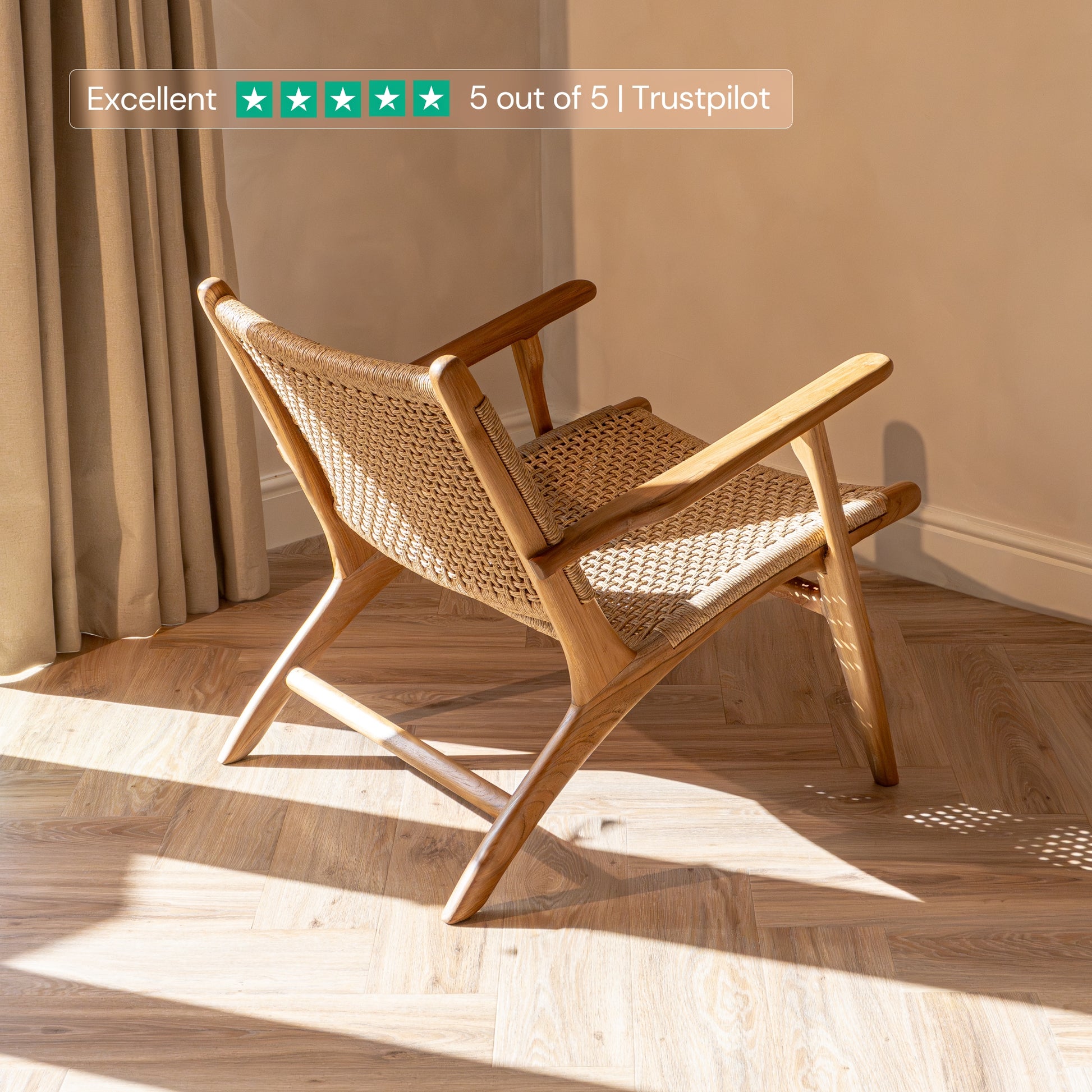 Rattan accent chair with wicker back and seat in a room with sunlight streaming through curtains