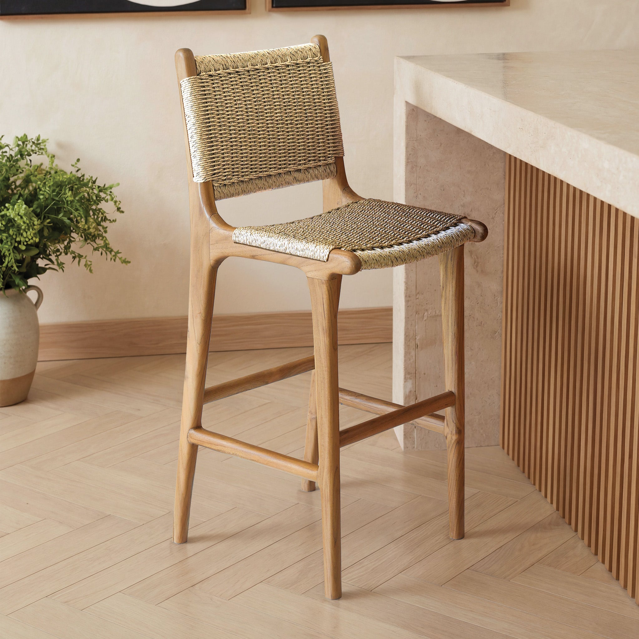Wooden bar stool with woven seat and backrest in a modern interior setting.