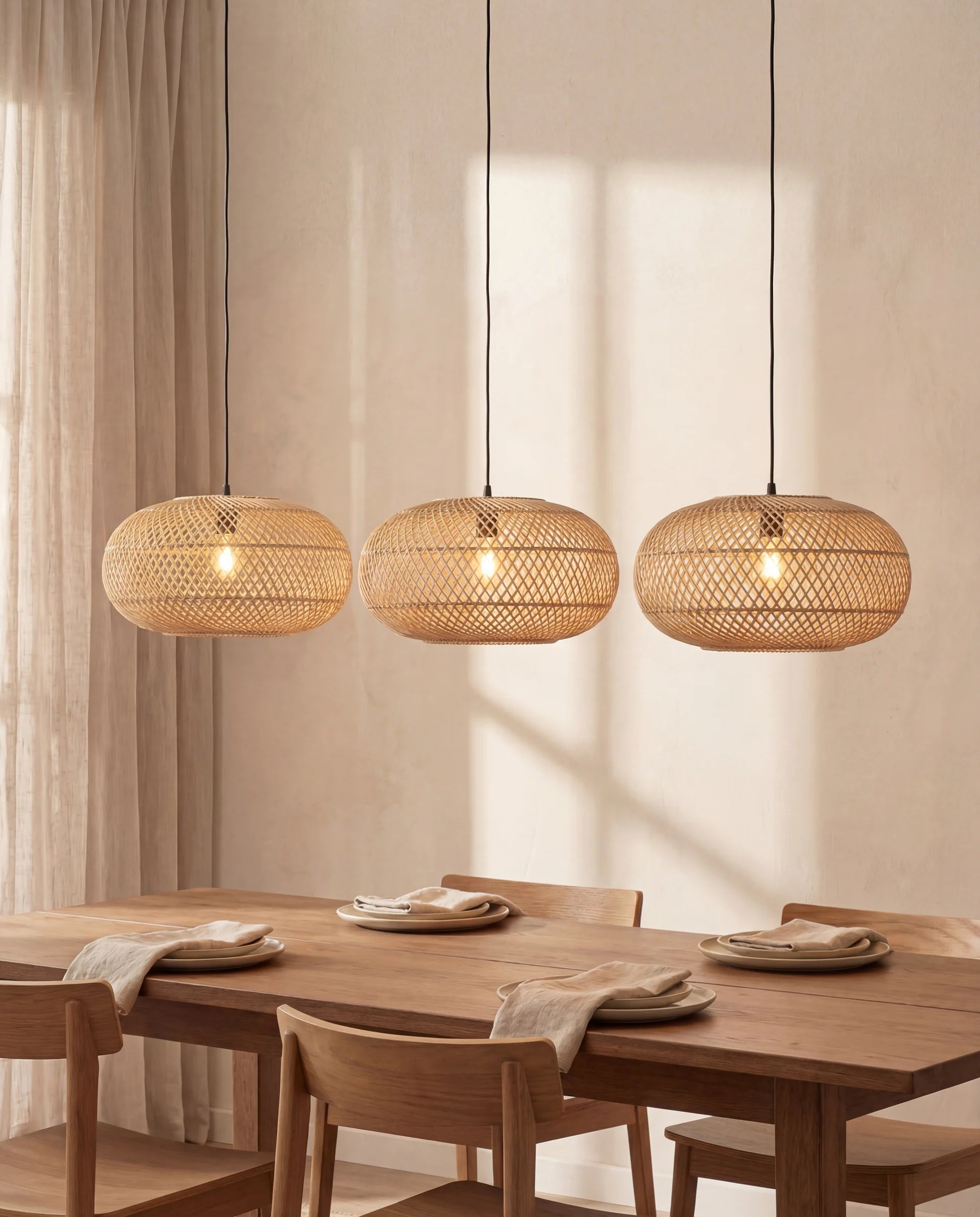 Dining room with wooden table and chairs, featuring three woven pendant lights.