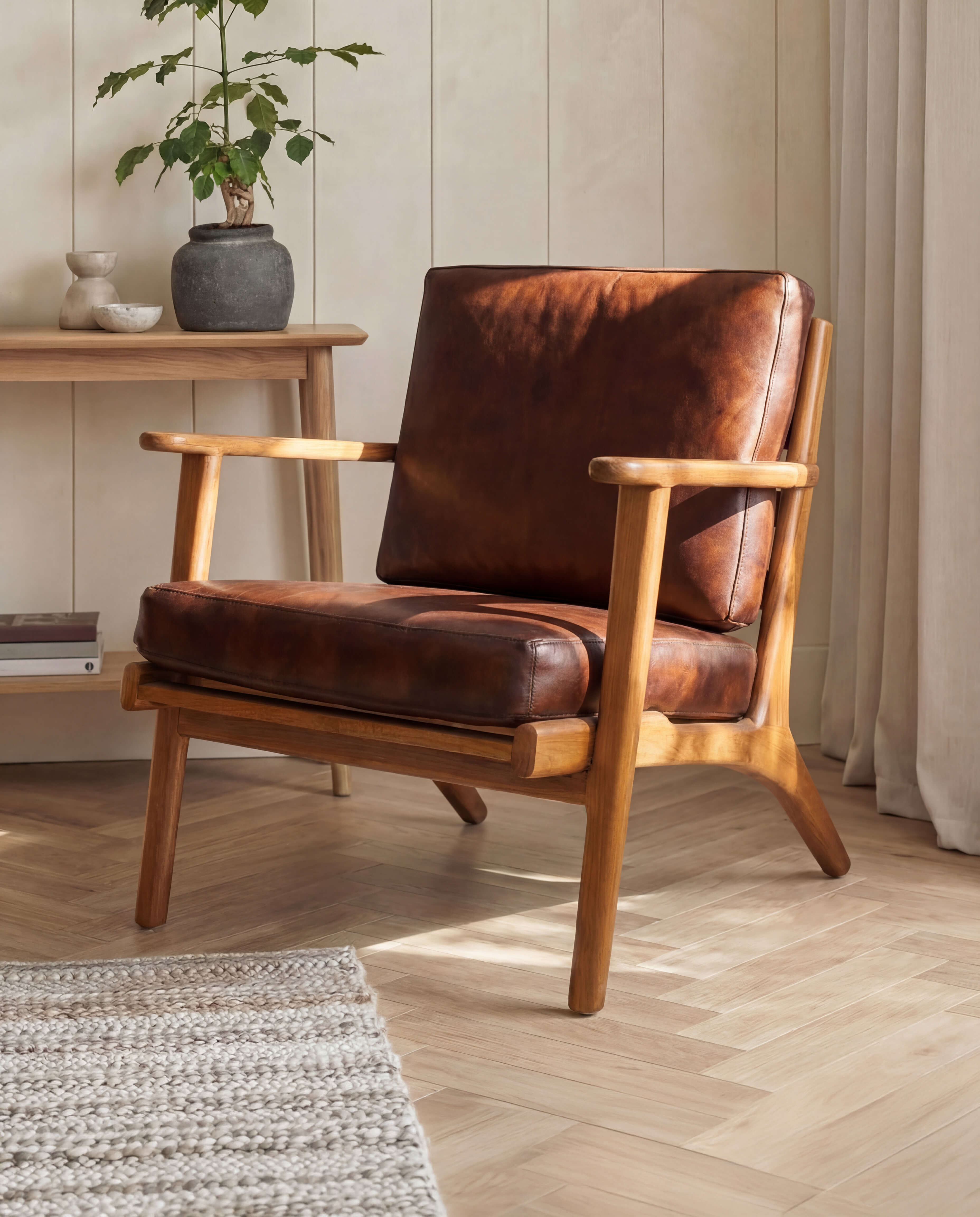 Brown leather armchair in a room with wooden floor and light-colored walls.