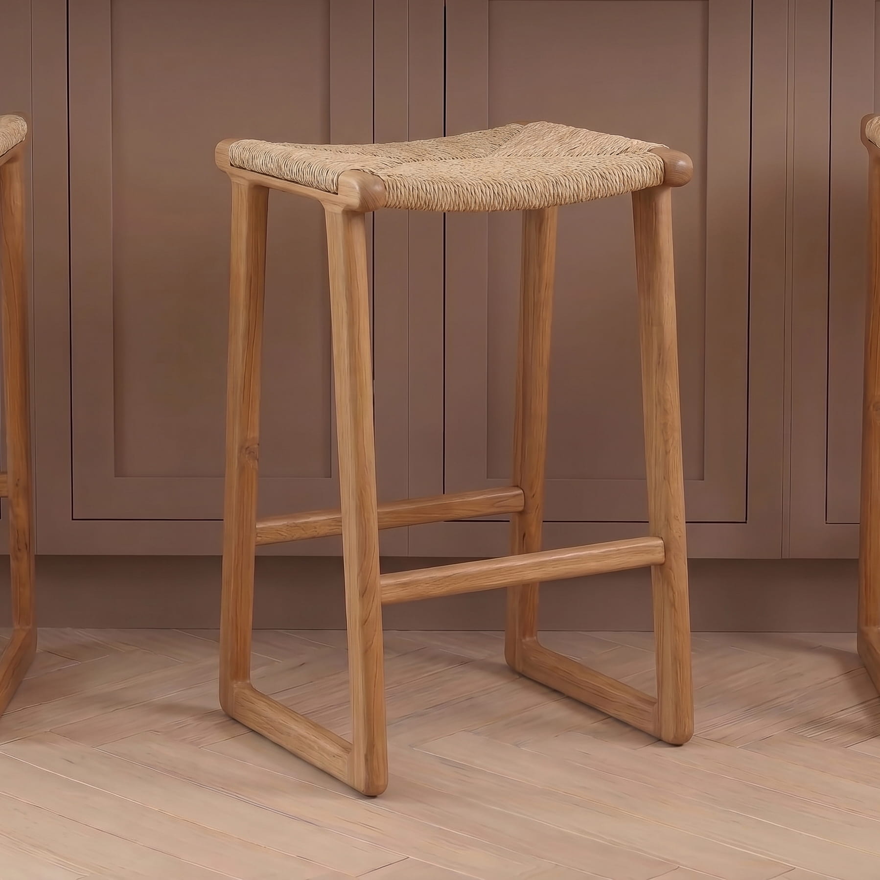 Wooden stool with woven seat against a brown paneled wall.